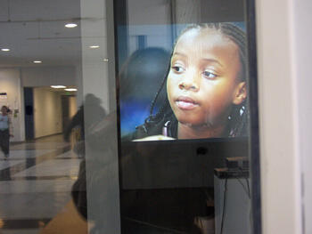 Photo of Carver-VCU After-School Arts Program student Evelyn Bell in a Stephen Vitiello sound and photo installation titled “Carver-VCU After-School Arts Program,” at the VCU Fine Arts Gallery in October 2006.  Photo by: Grace Johnston, department of arts education.