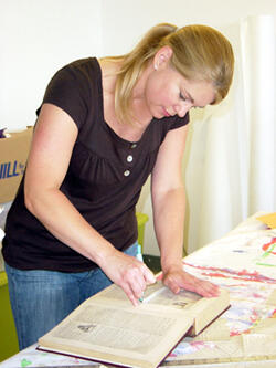 Diane Best, teaching assistant at Woolridge Elementary School in Chesterfield County, creates art from an encyclopedia in the bookmaking workshop. Enrollment in VCU’s Summer Workshop Series grew by 67 percent this year. Photo by Leila Ugincius, VCU Office of University Communications and Public Relations.