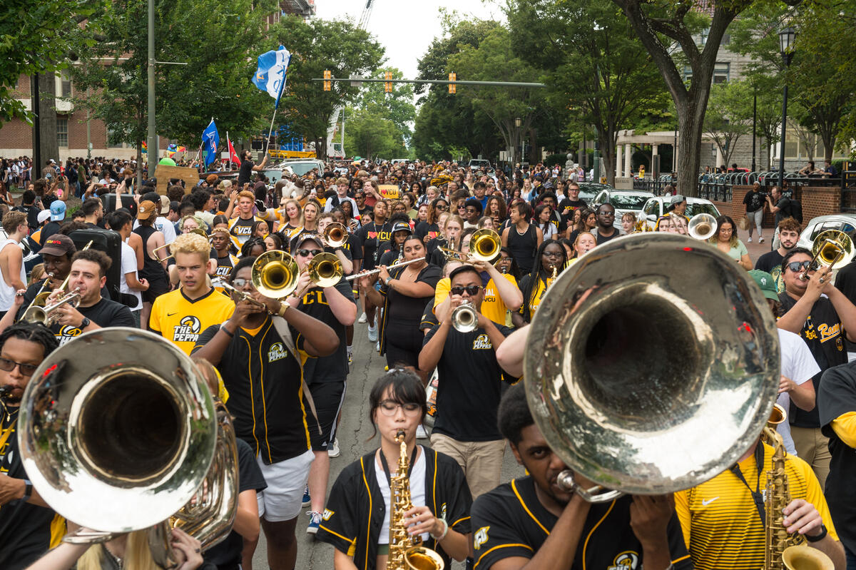 The pep band in front of a crowd of new students 