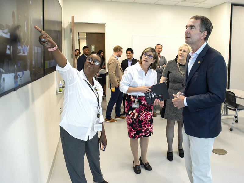 (From left) Beverly George-Gay, DNP, associate professor in the Department of Nurse Anesthesia, points to a screen showing the VCU College of Health Professions' two-way synchronous video conferencing capabilities as Nickie Damico, Ph.D., the department's chair, Susan Parish, Ph.D., dean of the college and Virginia Gov. Ralph Northam, M.D., look on.