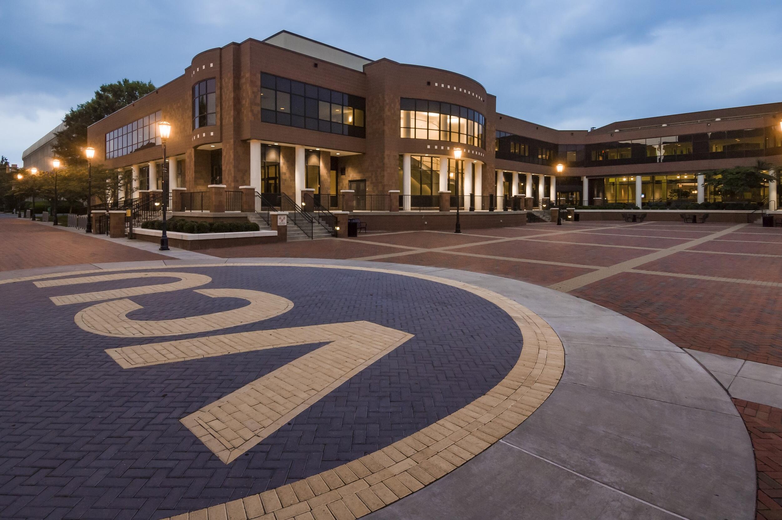 A photo of the Univesity Student Commons plaza at dusk 