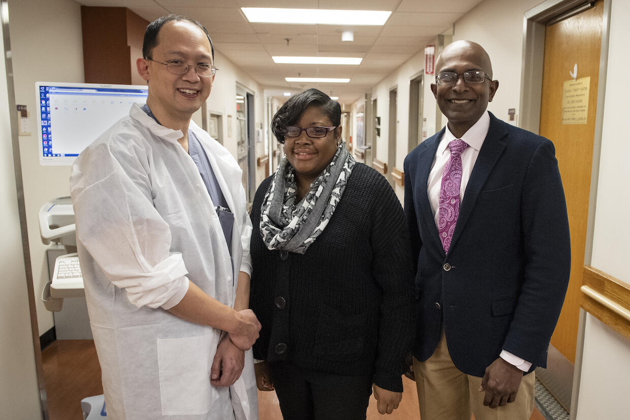 Cherron Gilmore, middle, with the VCU Health Pauley Heart Center surgeons who saved her life, Daniel Tang, M.D., left, and Vigneshwar Kasirajan, M.D.