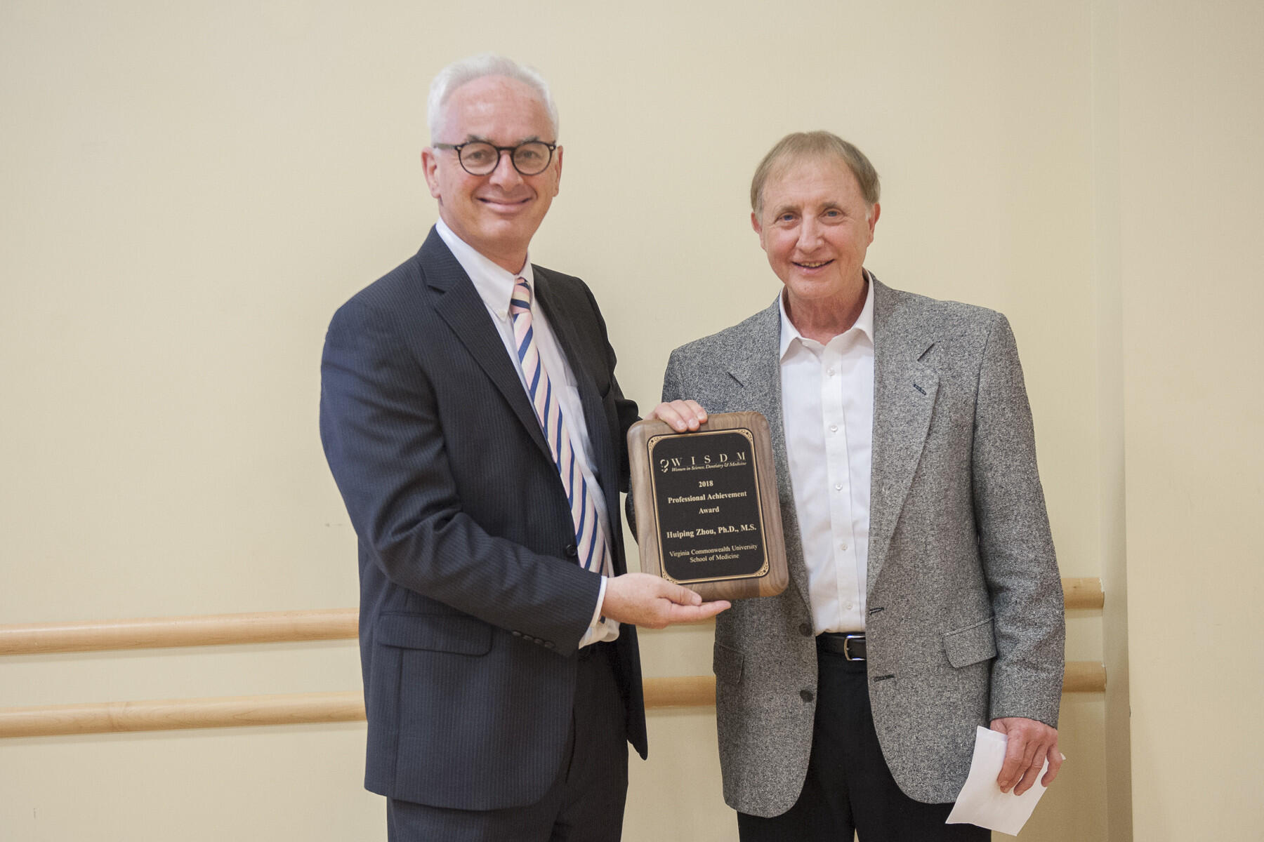 School of Medicine Dean Peter F. Buckley, M.D. with Phillip Hylemon, Ph.D., professor of microbiology and immunology. Hylemon accepted the WISDM Professional Achievement Award on behalf of Huiping Zhou, Ph.D., professor of microbiology and immunology at the VCU School of Medicine.