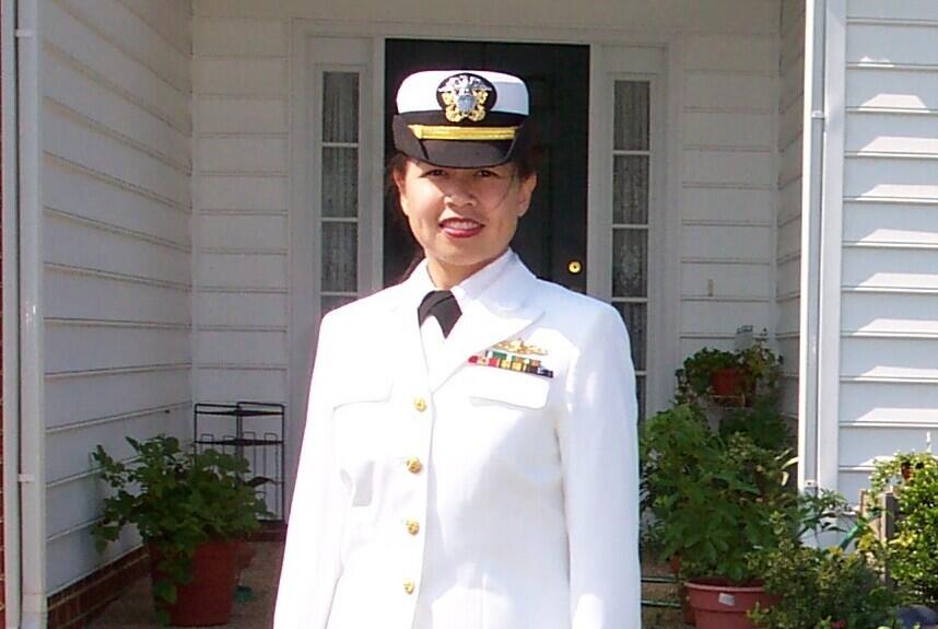 A photo of a woman wearing a white military uniform 