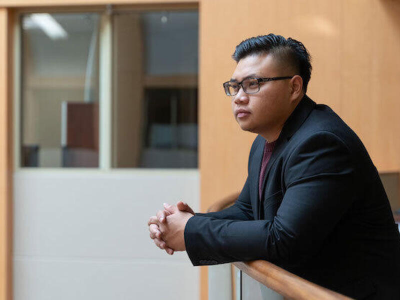 A person leaning on a rail.