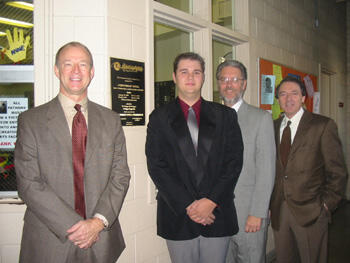 From left: Terry Austin, Ph.D., director of bands and professor in music education in VCU’s Department of Music; Adam Butalewicz, vice president of service, Kappa Kappa Psi fraternity; John Guthmiller, Ph.D., chair of VCU’s Department of Music; and Richard Toscan, Ph.D., dean of VCU’s School of the Arts stand by the newly dedicated plaque at Cary Street Gymnasium.