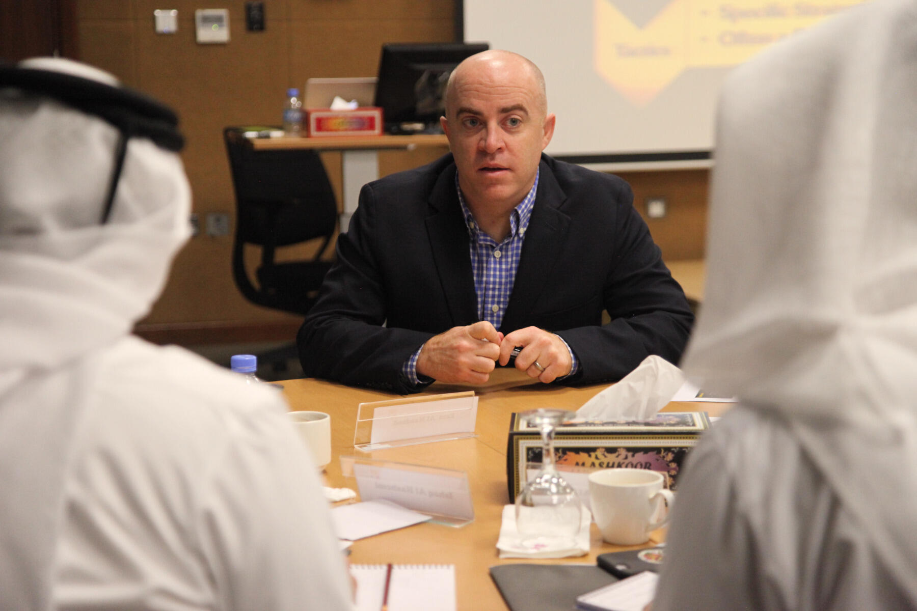 Brendan Dwyer, Ph.D., associate professor and director of research and distance learning for the Center for Sport Leadership, conducts a training session with members of the Qatar Olympic Committee.