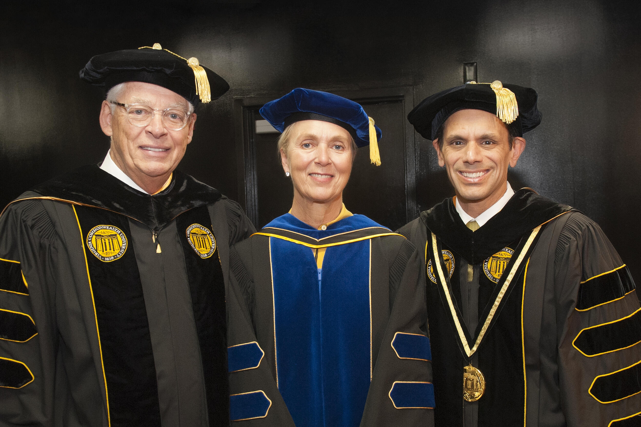 Bill Royall, left, with Pam Royall and VCU President Michael Rao at VCU's May 2017 commencement ceremony