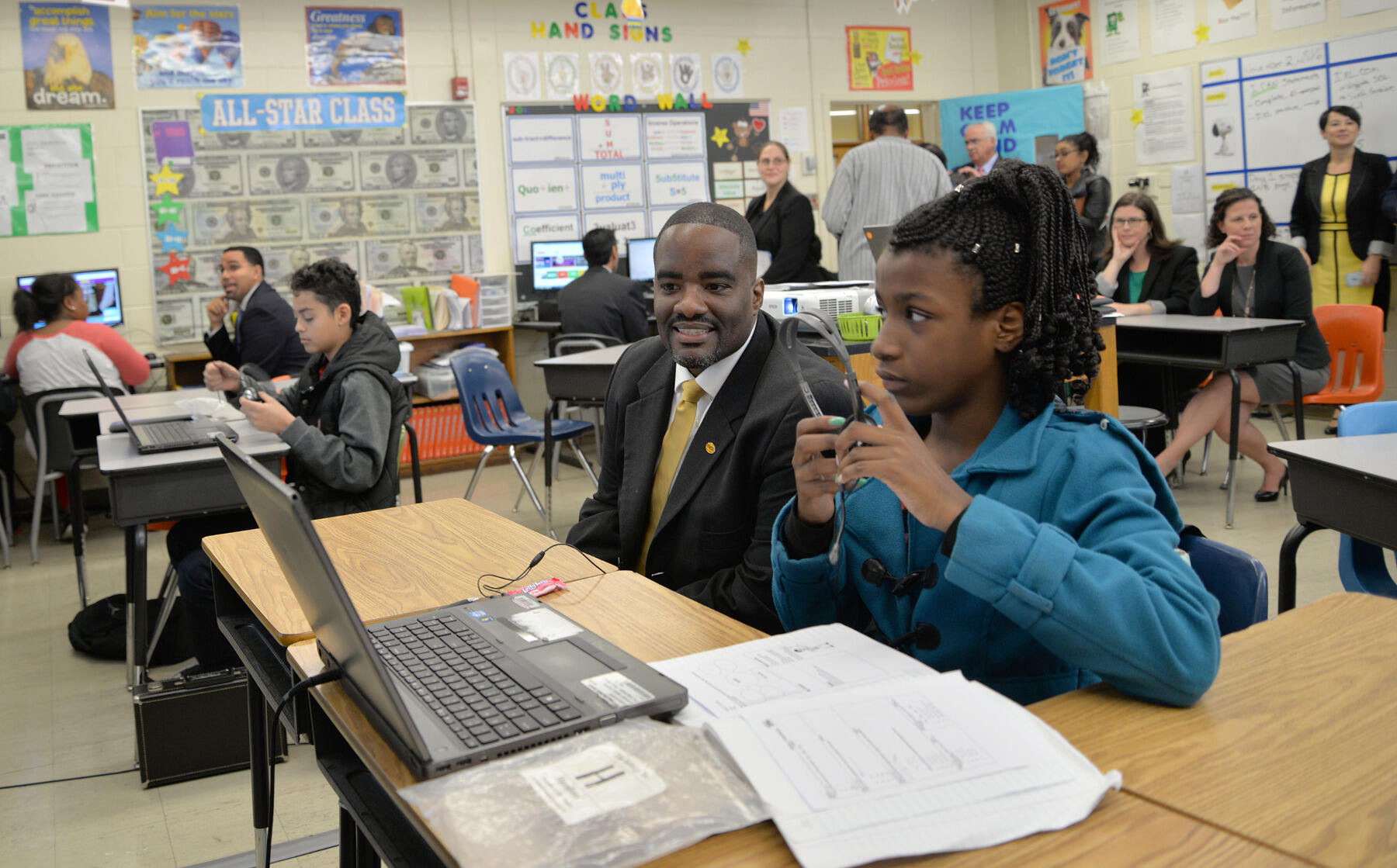 VCU School of Education Dean Andrew P. Daire, Ph.D., sits with a student during a math class taught by Richmond Teacher Residency resident Dana Lockhart and mentor teacher Donovan Tucker.