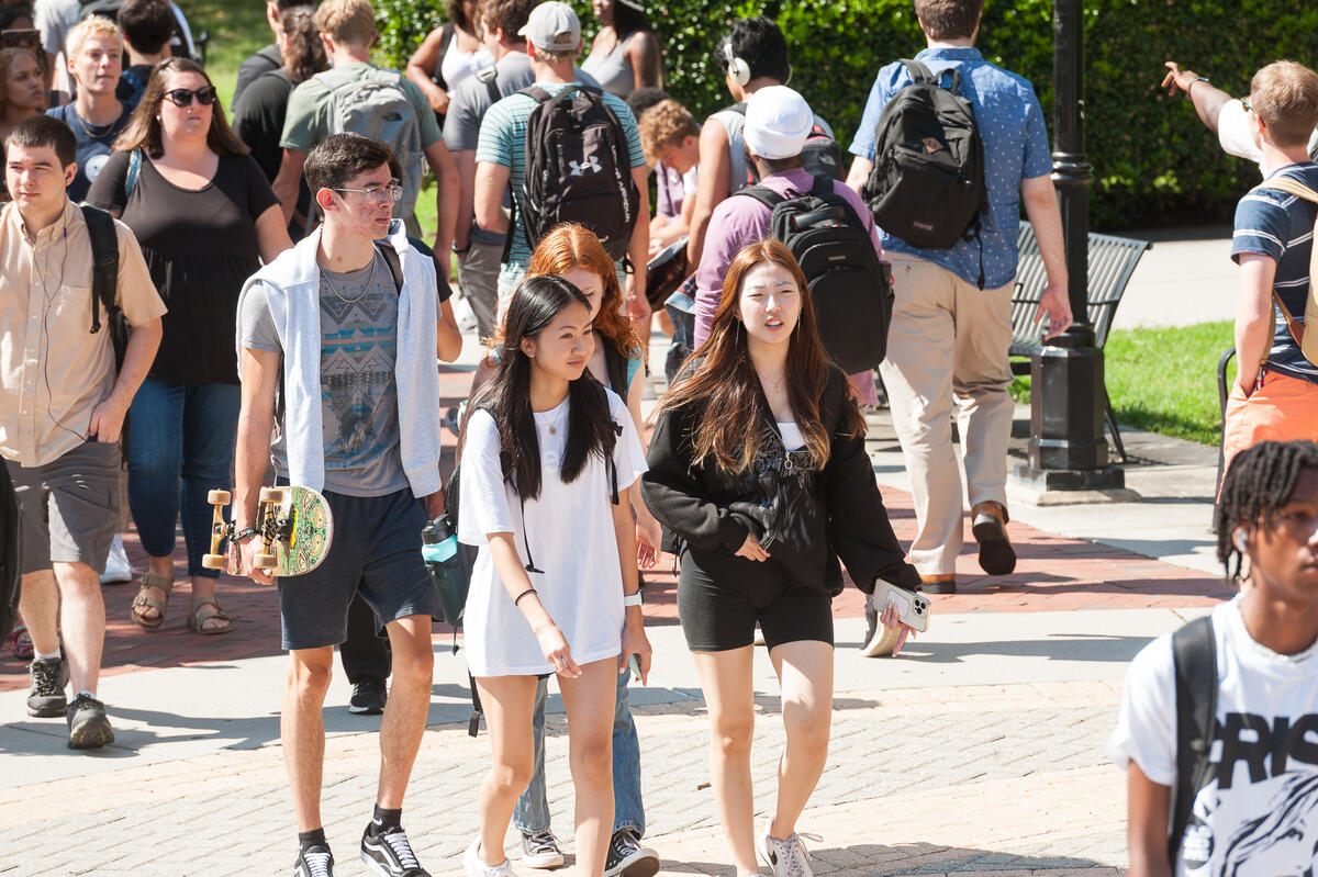 students walking across the commons plaza 