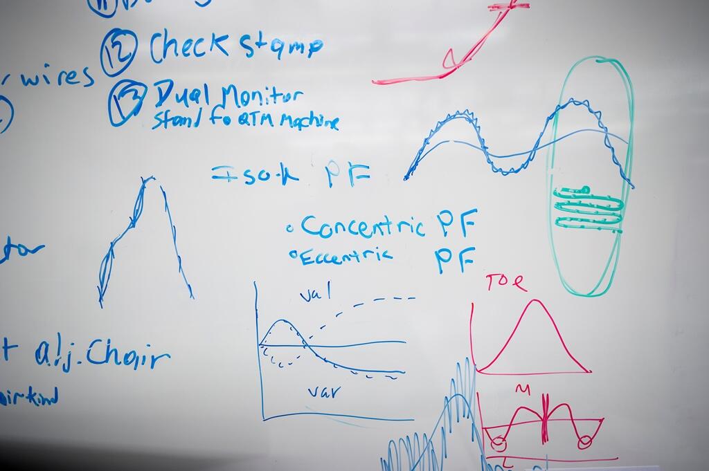 Researchers chart the biomechanics of runners on the lab’s white board. 
