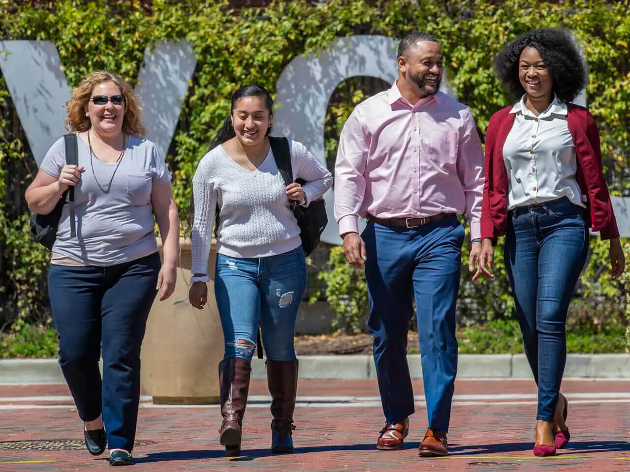Four people walk together.