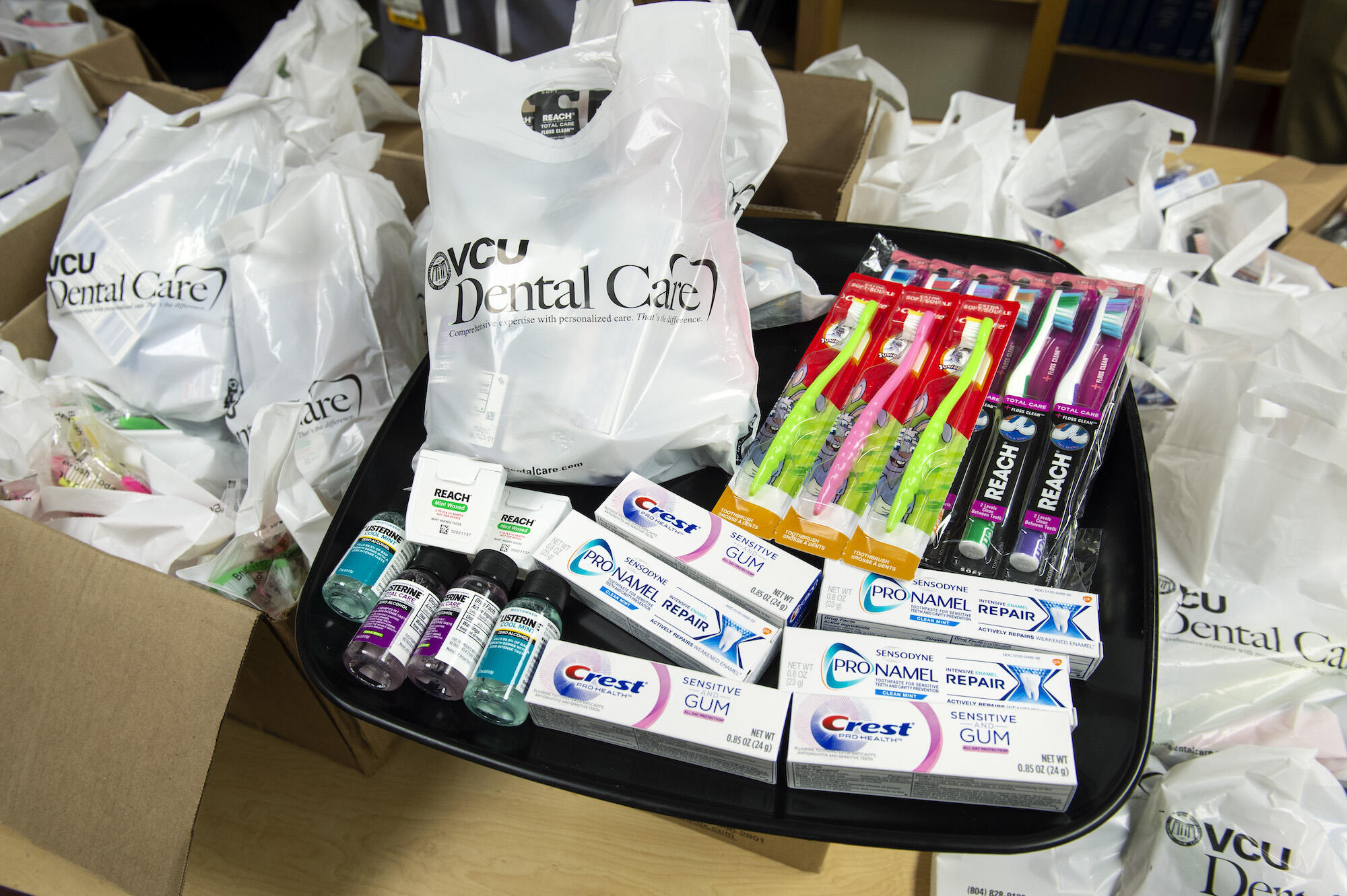 dental supplies, including toothpaste, toothbrushes and dental floss, in bags