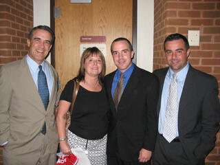 Graduate Carlos P. Nido, (second from right), shares a moment with family members following 32nd Basic Academy graduation exercises.  The academy sharpens skills and improves marketability for participants.  Nido has already landed a law enforcement job in Goochland County. Photo by: Leila Ugincius/University News Services
