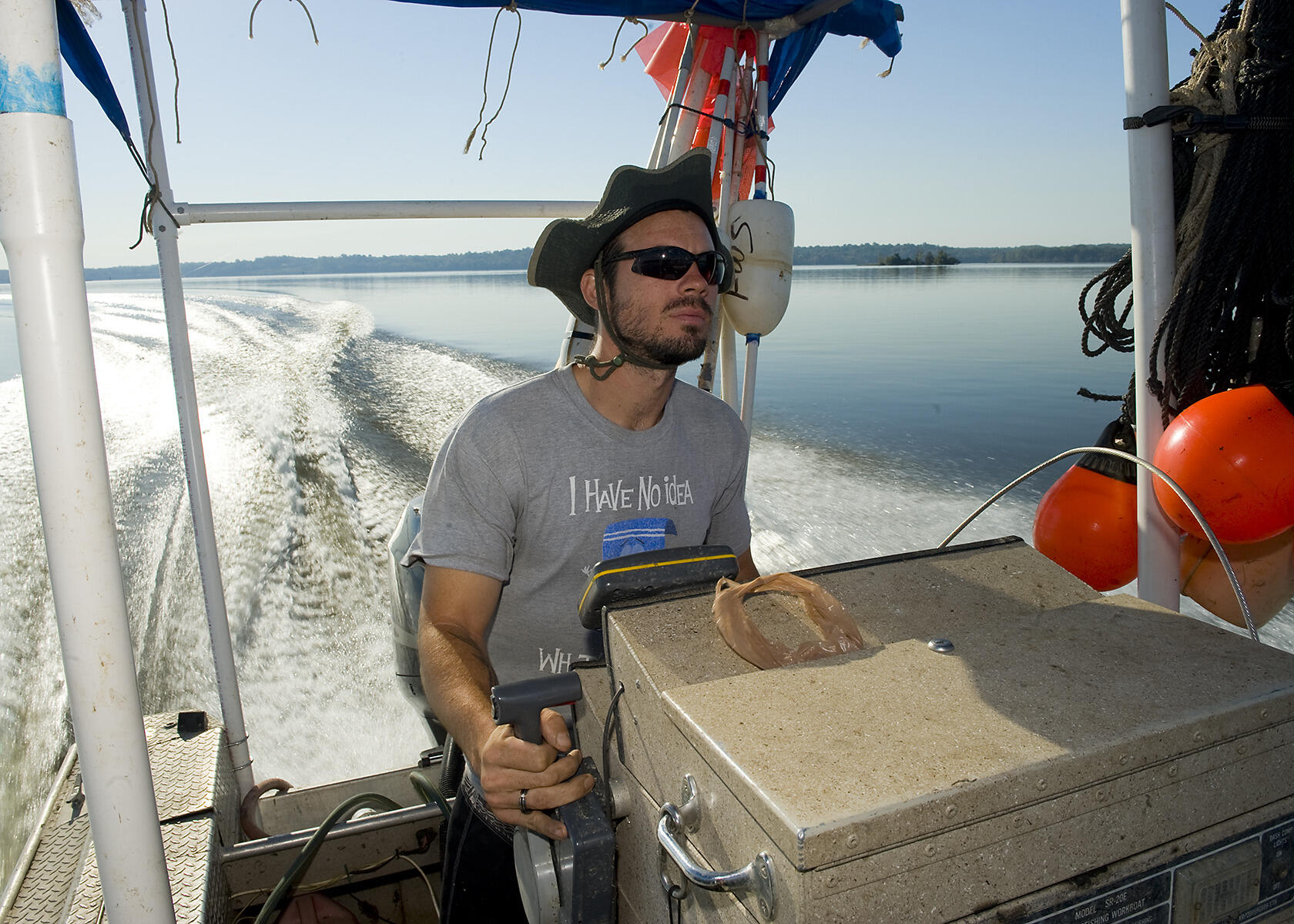Matt Balazik, Ph.D., on the water for sturgeon restoration work. Numbers of the prehistoric fish are growing in the James River. (Photo by Allen Jones, University Relations)