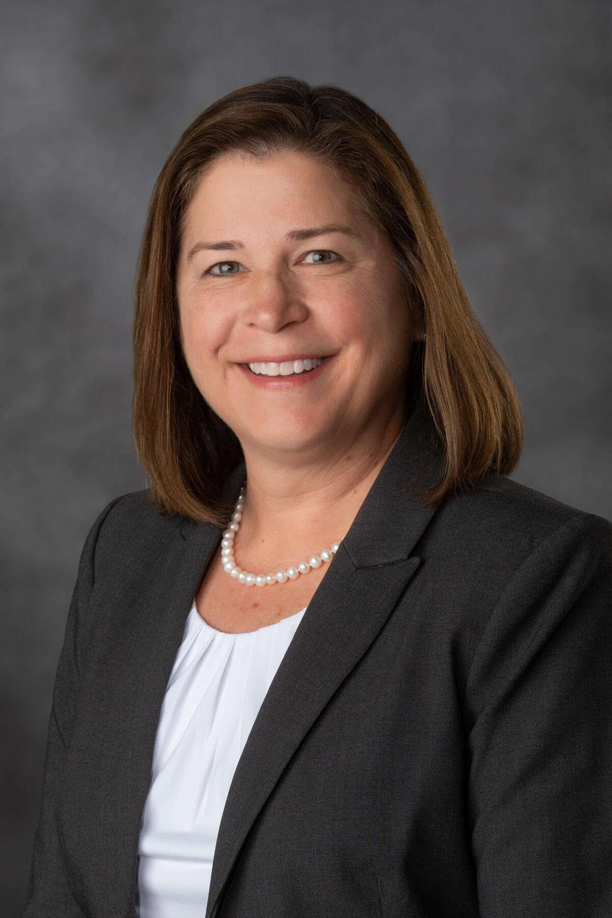 Smiling woman in business attire.