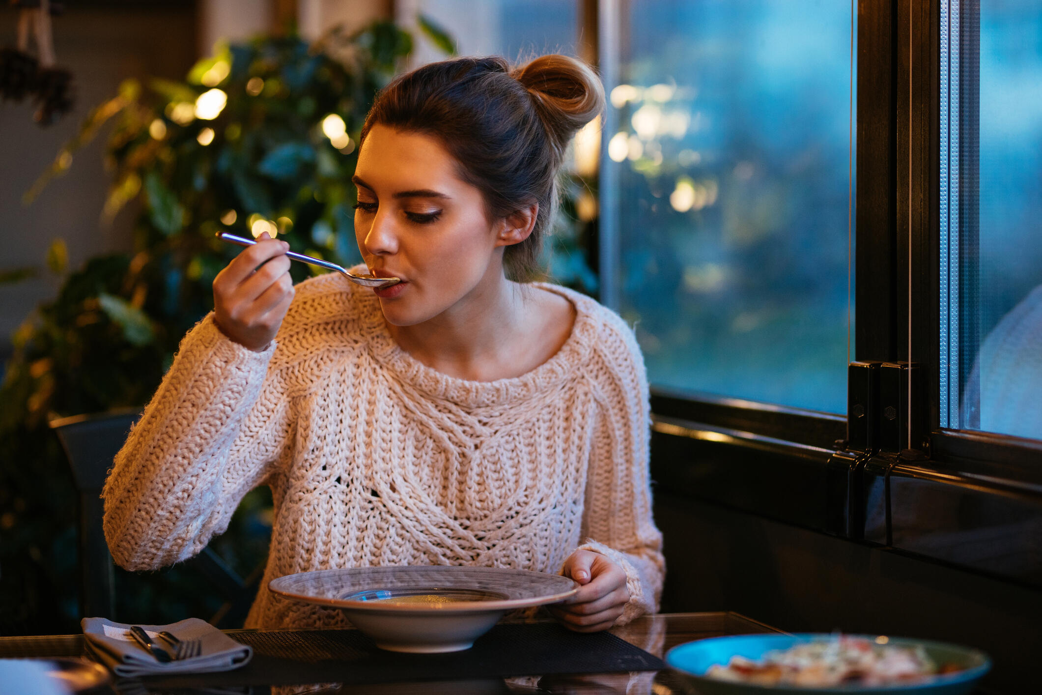woman eating food from a bowl.