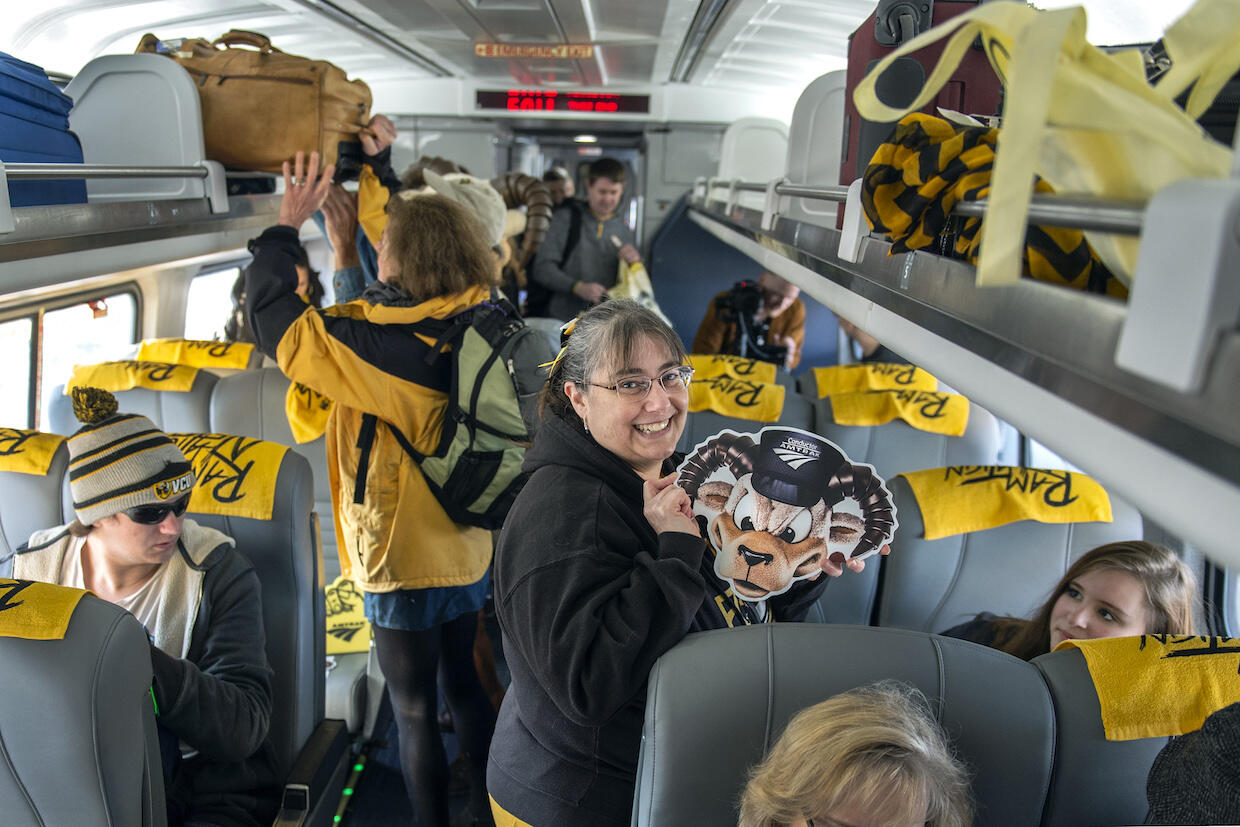 April Sullivan with her children, Matthew, left, and Katie, right, on the RamCar heading to the Atlantic 10 men's basketball tournament. (Photo by Kevin Morley, University Marketing)