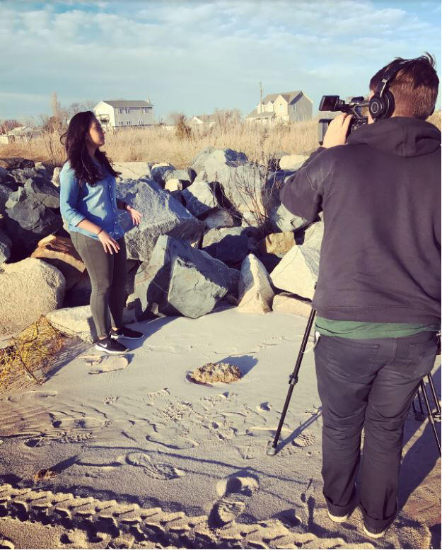 VCU InSight student journalists Hiba Ahmad and John Hood shoot footage on the shores of Tangier Island.

