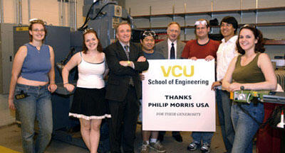 From left, engineering students Kerri Dyke and Kimy Despain; Philip Morris USA Vice President of Product Development and Technology Hector Alonso; student Chia Chiu; School of Engineering Dean Robert J. Mattauch; and students John Yarbrough, Brian Le and Leah Lovell in the School of Engineering's new machine shop. Eight Metal and nonmetal fabrication machines were a gift to the School from Philip Morris USA.