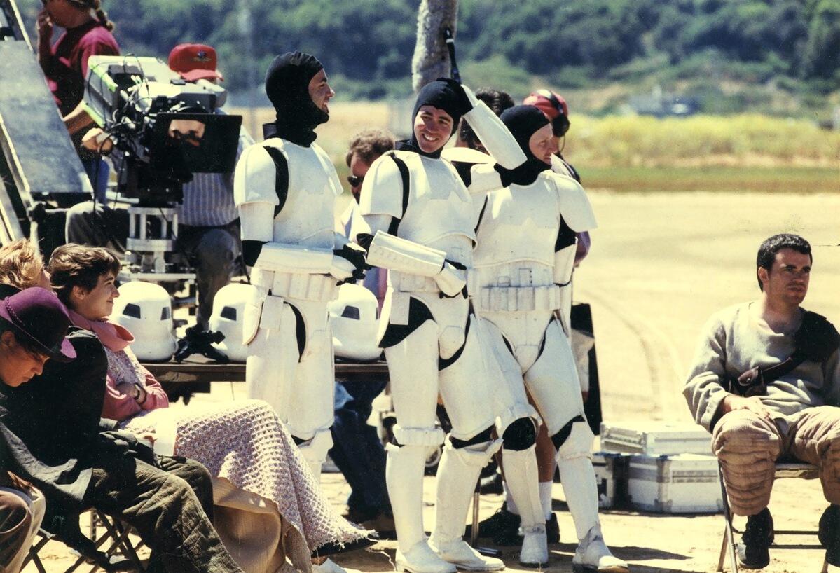 Three men wearing storm trooper uniforms on the set of star wars 