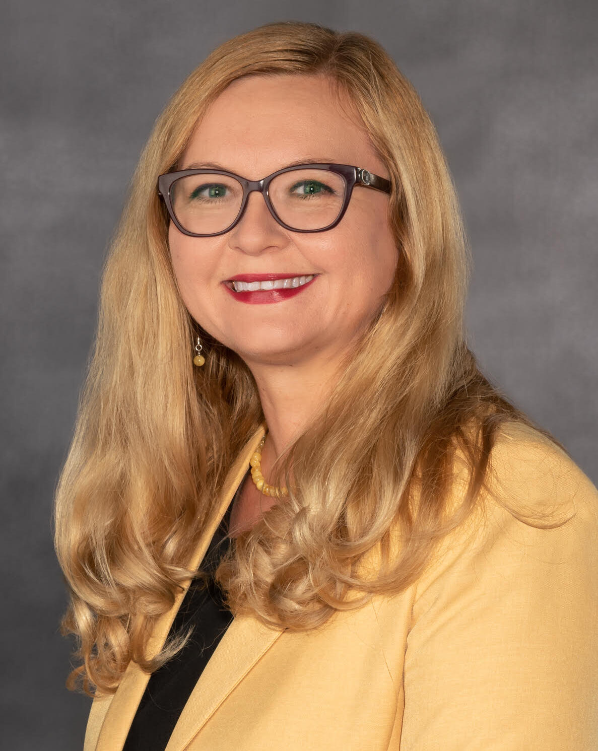 A photo of a woman from the chest up. 