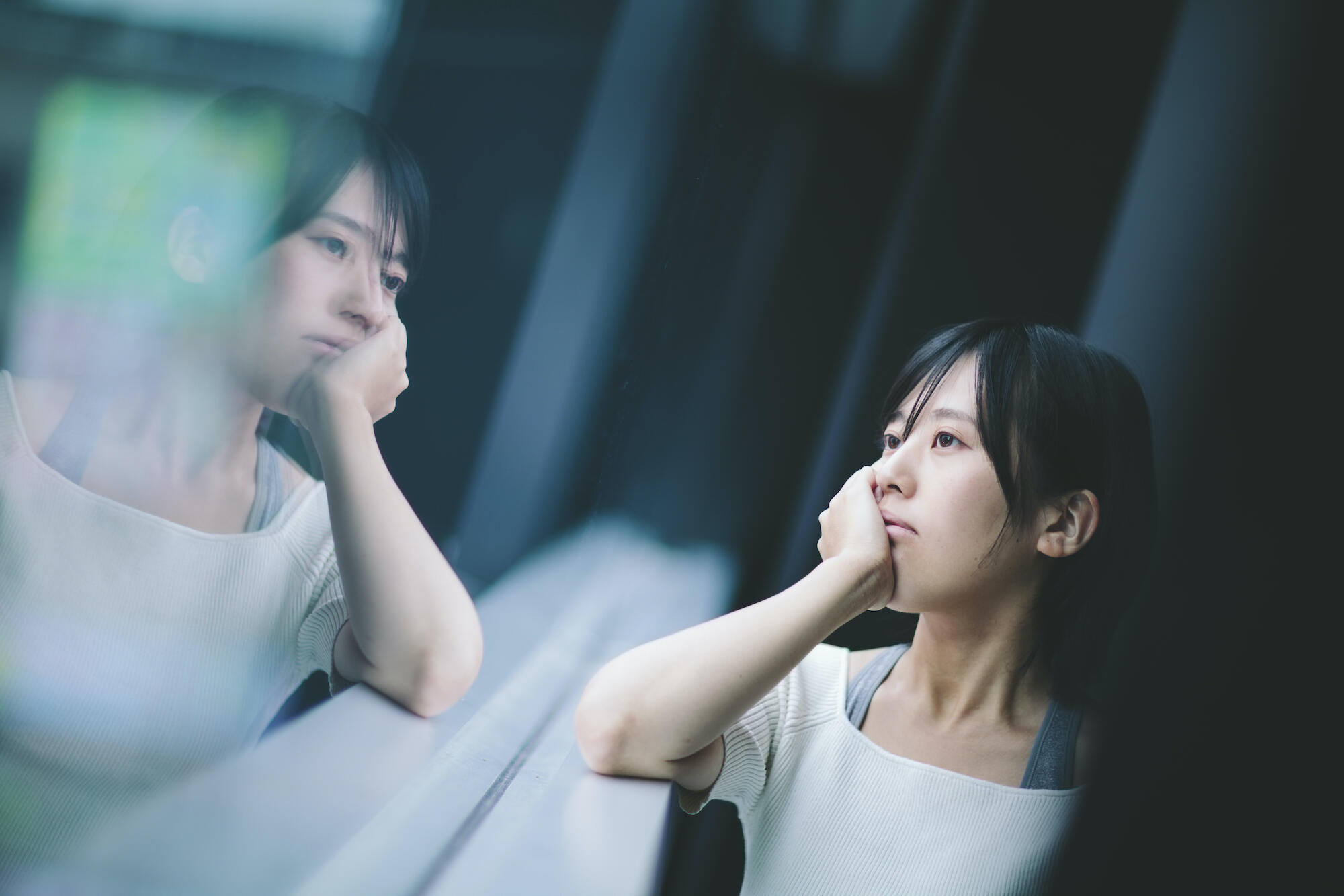 woman with depression staring out the window