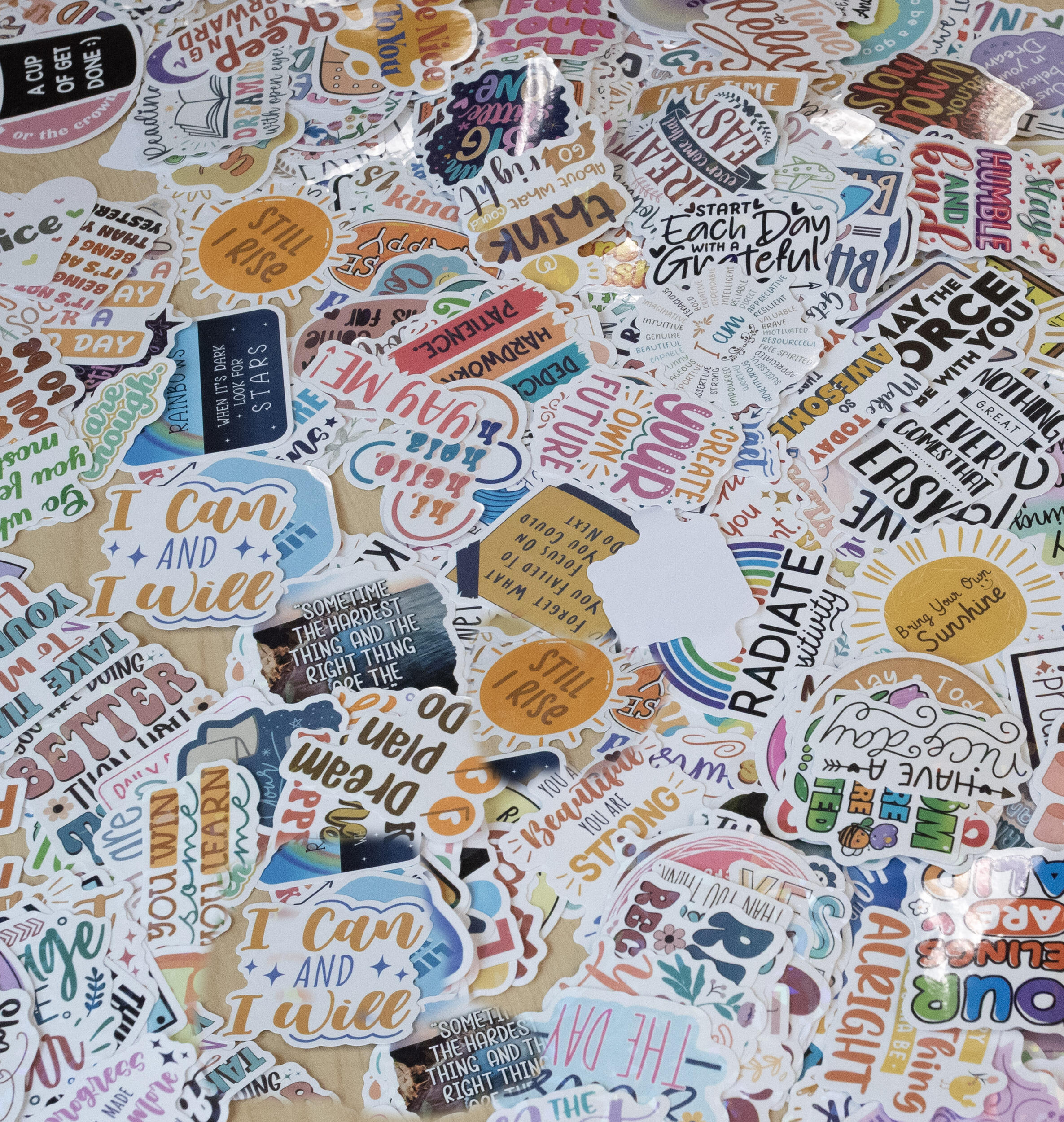 A photo of a table covered in stickers with positive affirmations written on them. 