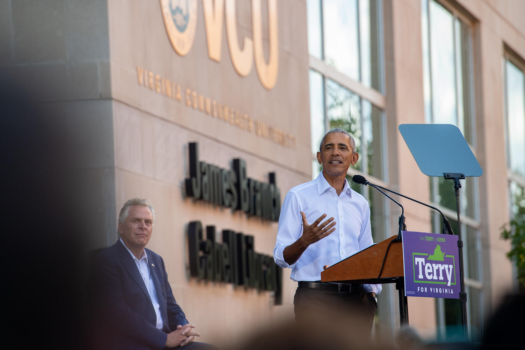 Barack Obama addresses a crowd of 2,000 outside James Branch Cabell Library on Saturday. Terry McAuliffe sits behind Obama