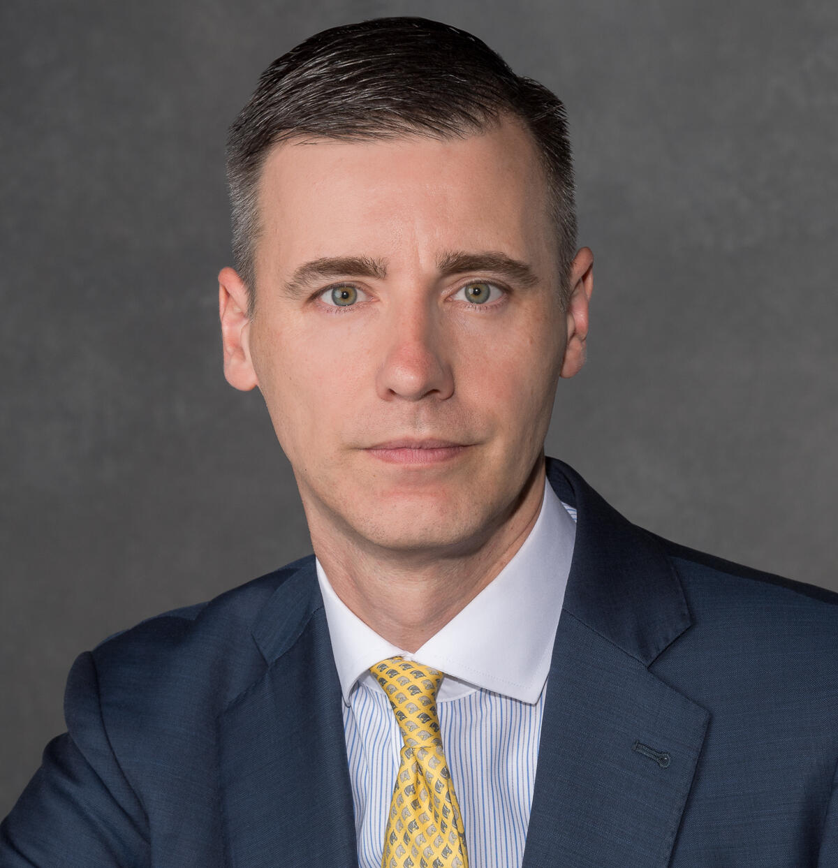 A photo of a man from the shoulders up. 