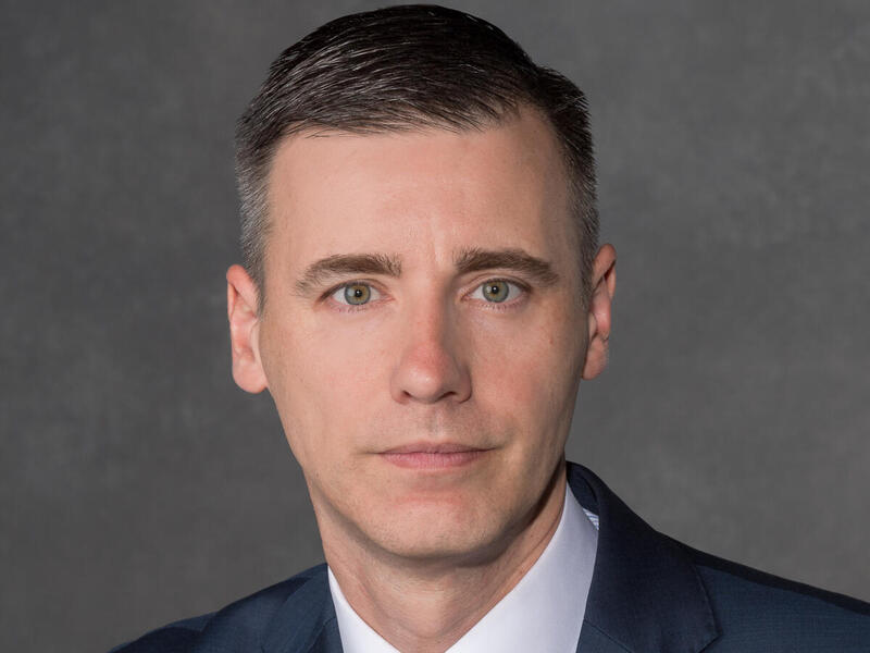 A photo of a man from the shoulders up. 