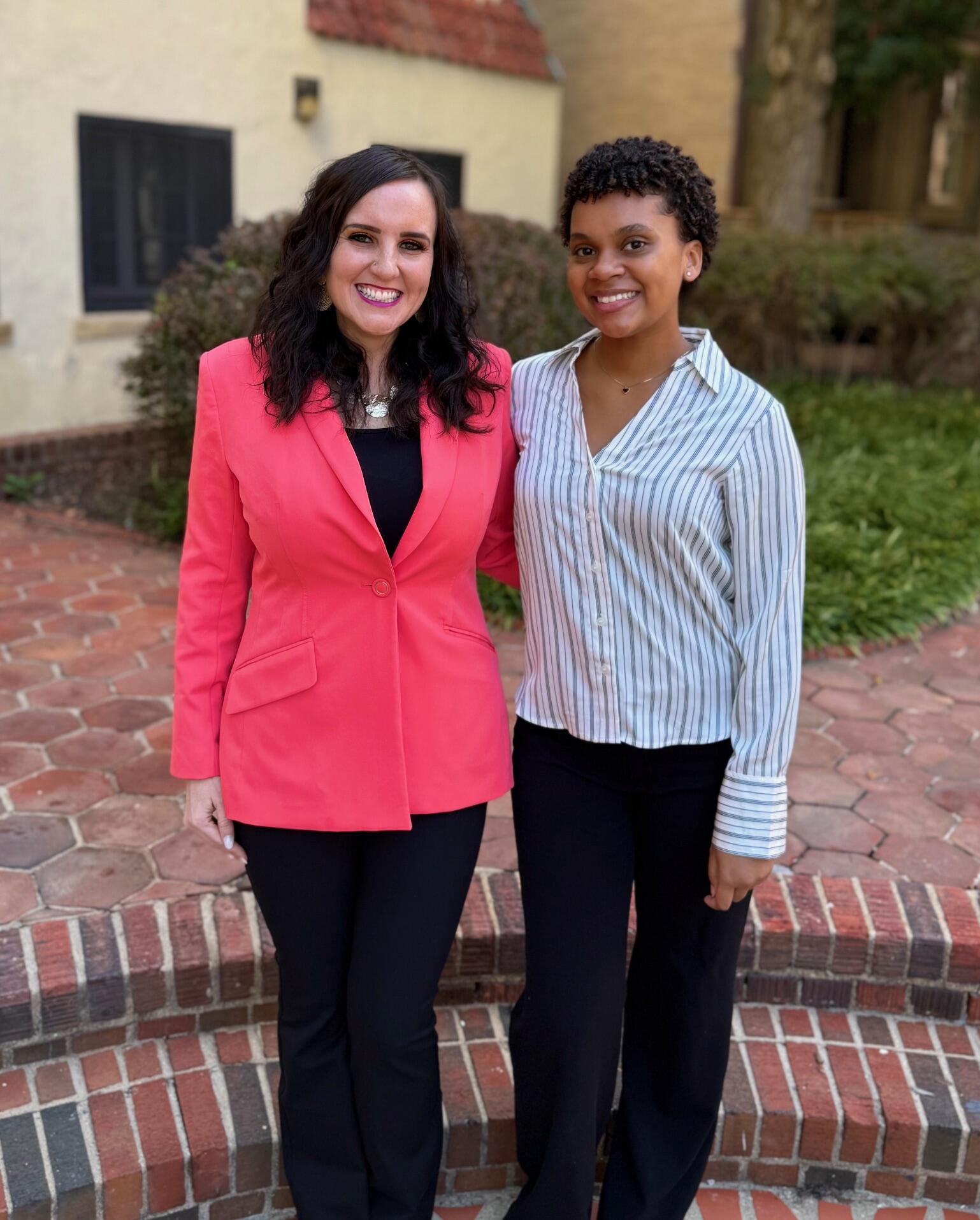 A photo of two women standing next to each other. 