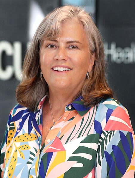A woman wearing a multicolored shirt 