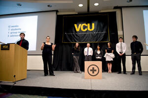 The Phase II da Vinci group, and Jennifer Farris, second from left, from the Phase I group, present the prototype for a $500 operating table for developing countries, during da Vinci Day at VCU on April 15. The box in the foreground is the table in its shippable form. From left: Mike Garrett, Farris, Lauren O’Neill, Chris Johnson, Ana Cuison, Jennifer Koch, Michael Mercier and Skylar Roebuck. (Photo by Allen Jones, VCU Creative Services.)