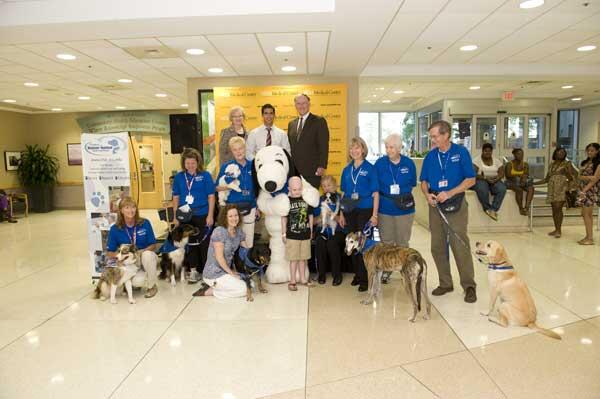 Snoopy poses with representatives of VCU, Kings Dominion and the Dogs on Call program.