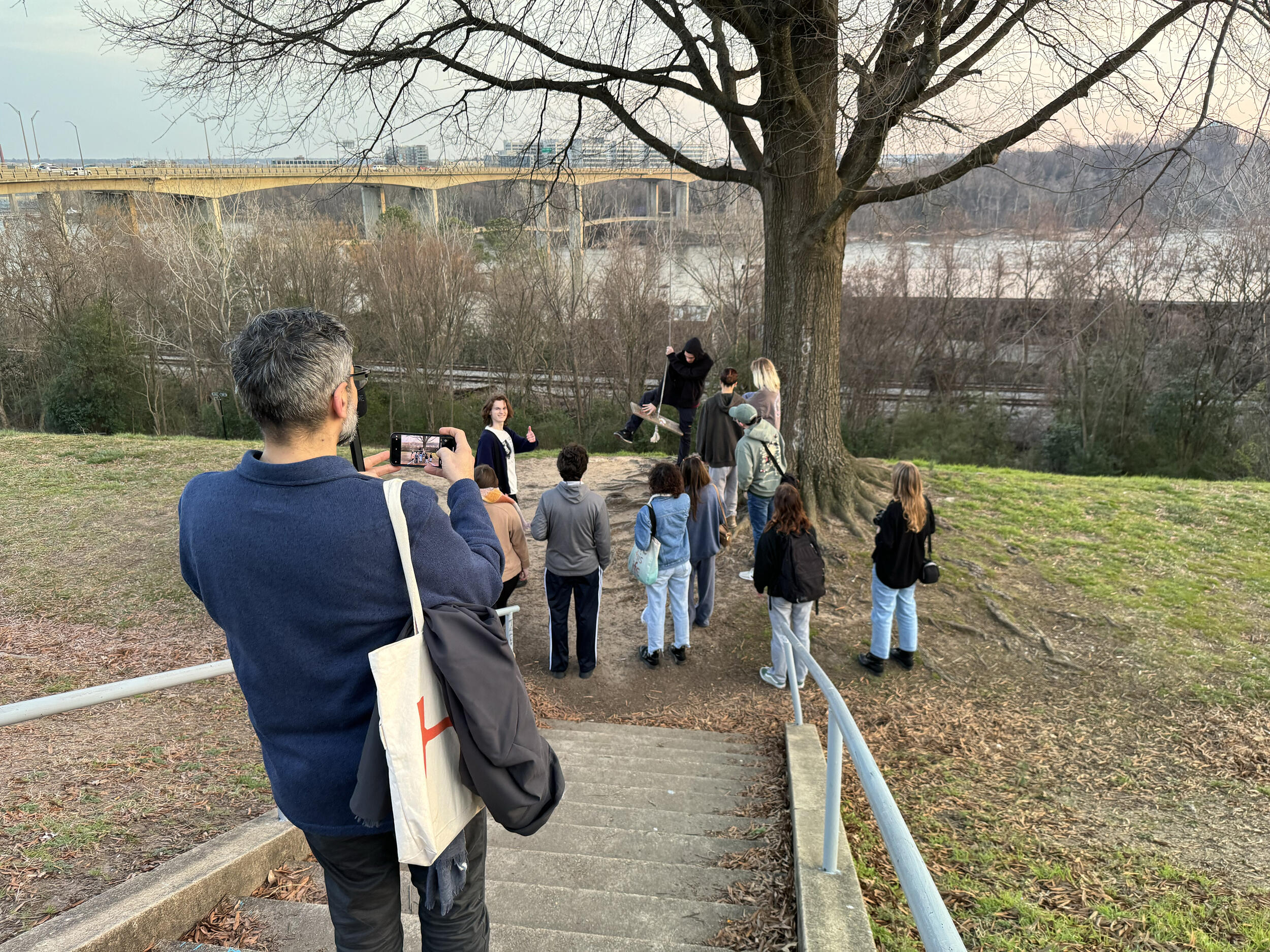 A photo of people walking down a hill. 