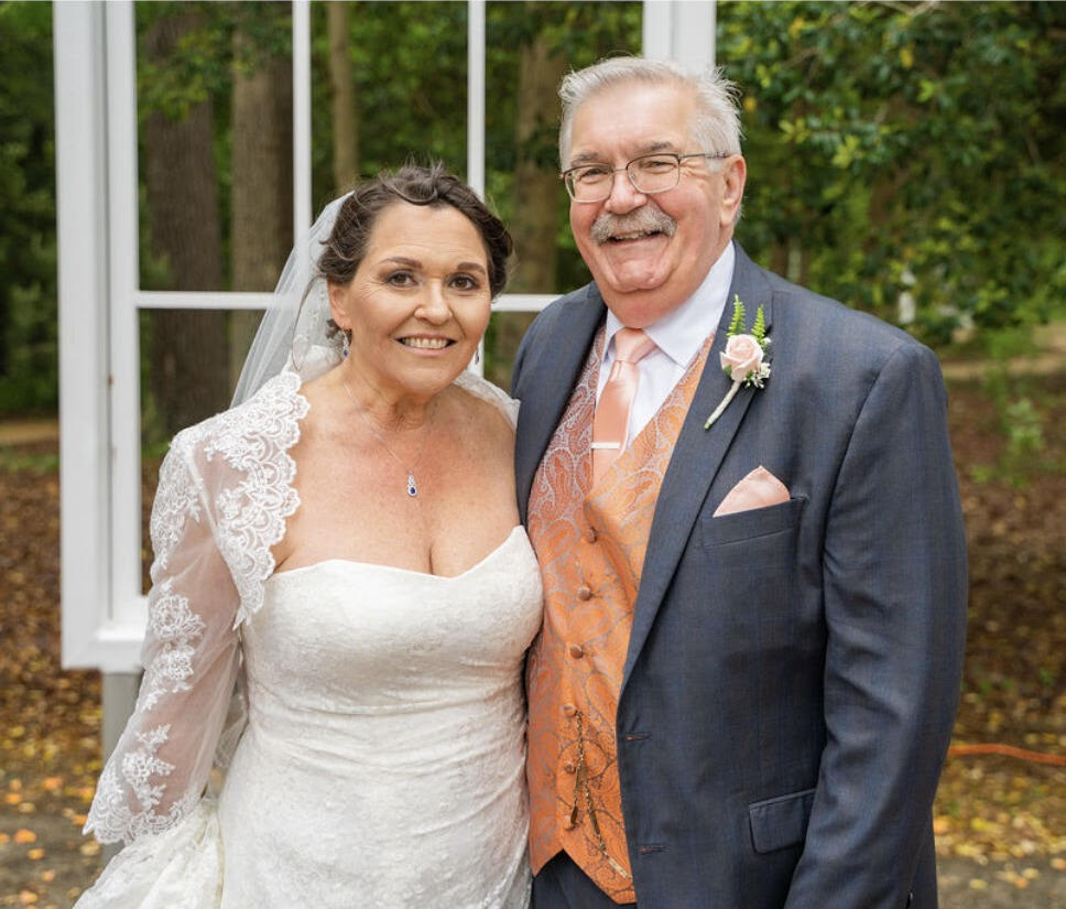 A bridge and groom smiling.