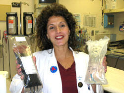 Dr. Therese Duane shows PolyHeme and saline solution, the two blood expanders that will be used by first responders in the proposed study.

Photo Credit: Michael Ford, University News Services