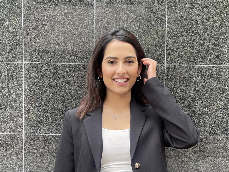 Dikshya Baral standing in front of a marble wall 