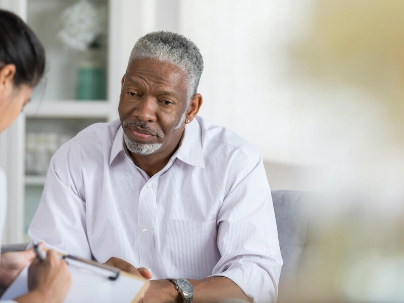 Two people participating in a therapy session.