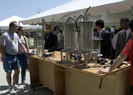 Robert Northcutt, a mechanical engineering major at VCU, talks with visitors viewing senior design projects about the "see-through" reactor that he and other students fabricated. The see-through reactor will provide nuclear engineering students with hands-on experience, as the VCU School of Engineering moves to the forefront of nuclear education in Virginia. Photo by Melissa Gordon, VCU Communications and Public Relations.