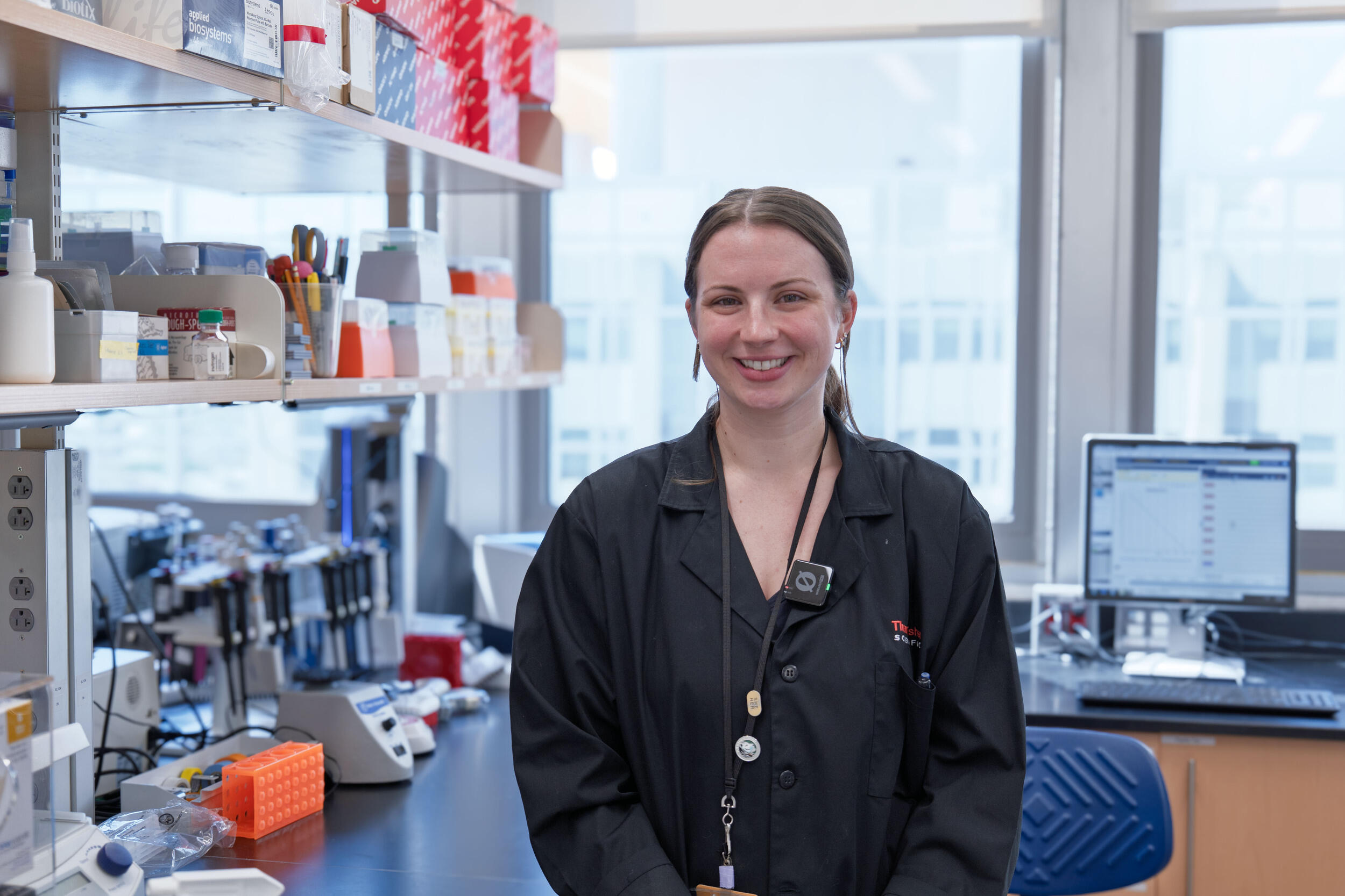 A photo of a woman standing a science lab.