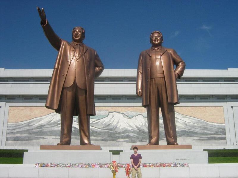 Benjamin Young stands in front of the two giant statues at the Mansu Hill Grand Monument in North Korea.