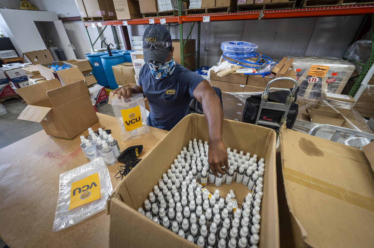 A VCU Facilities Management employee putting together personal protective equipment supply kits.