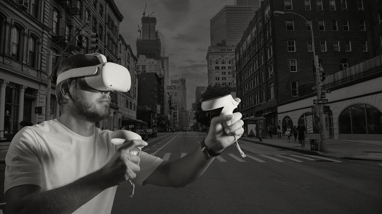 A photo of a man wearing a VR headset. The background is a city street. 
