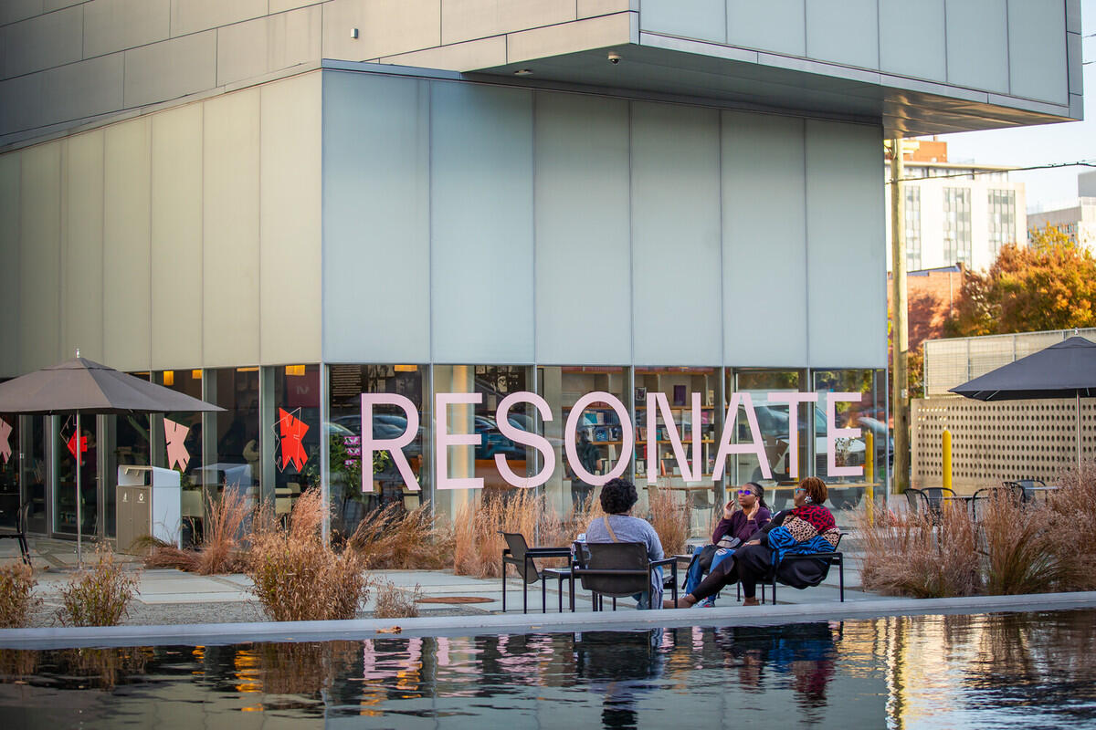 A picture of the Institute for Contemporary Art with the word \"RESONATE\" written across the bottom level's window in pink letters. 