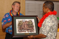 Dr. Stephen D. Gottfredson, left, presents Dr. McDavis with a keepsake framed print of Ginter House-the location of McDavis' VCU office. Gottfredson, who held the post as dean of the College of Humanities and Sciences, has been named interim provost and vice president for Academic Affairs.