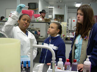 Lashanta Smart, junior in clinical laboratory science program, shows two Girls Scouts how to test for blood type. Photo by Anna Goroncy