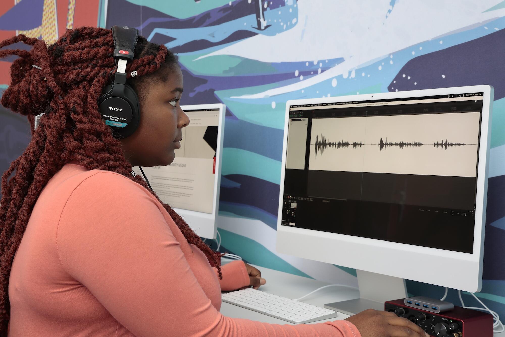 Young woman editing audio at the VPM+ICA Community Media Center.