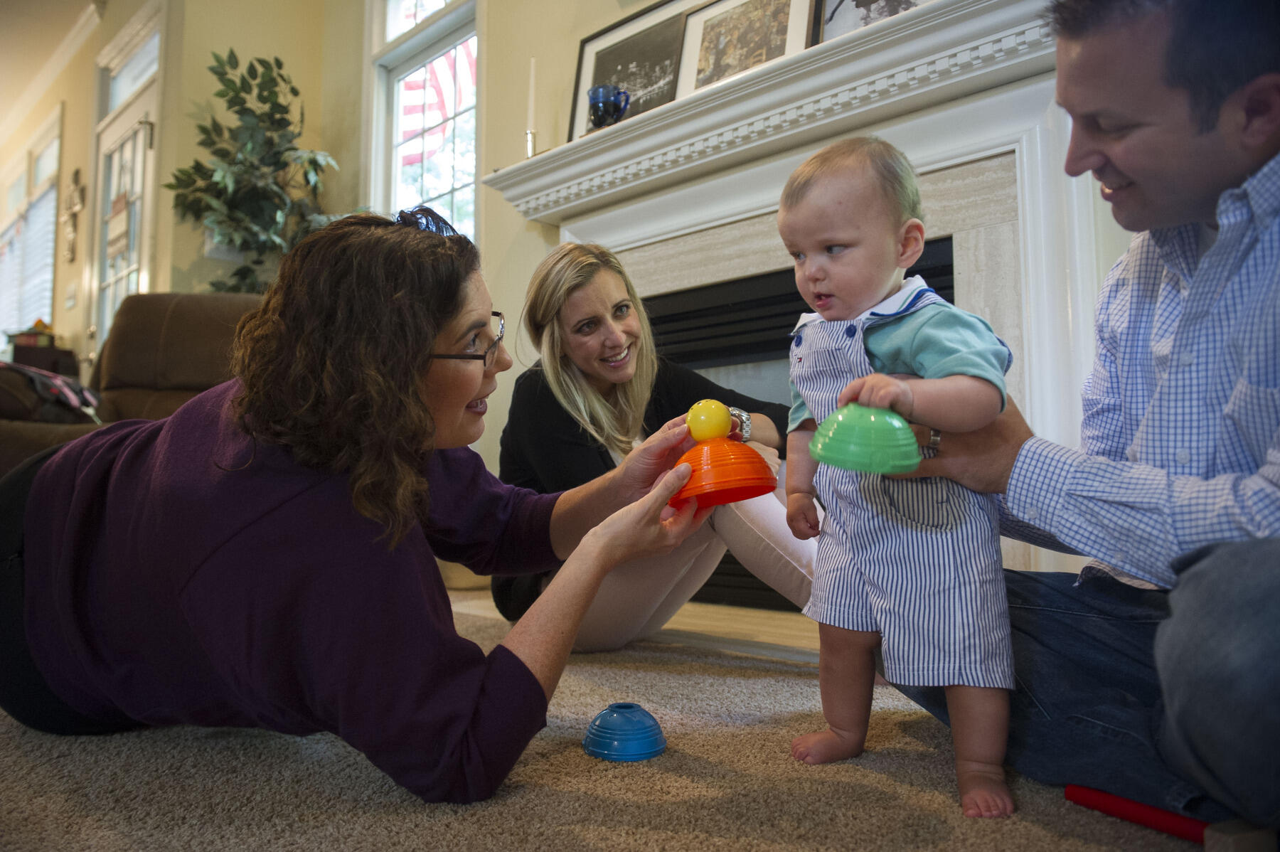 Stacey Dusing, Ph.D., associate professor in the Department of Physical Therapy, works with Miles Mrozinski at home with his parents, Whitney and Brent Mrozinski. Miles has been part of the START-Play Program since April.
